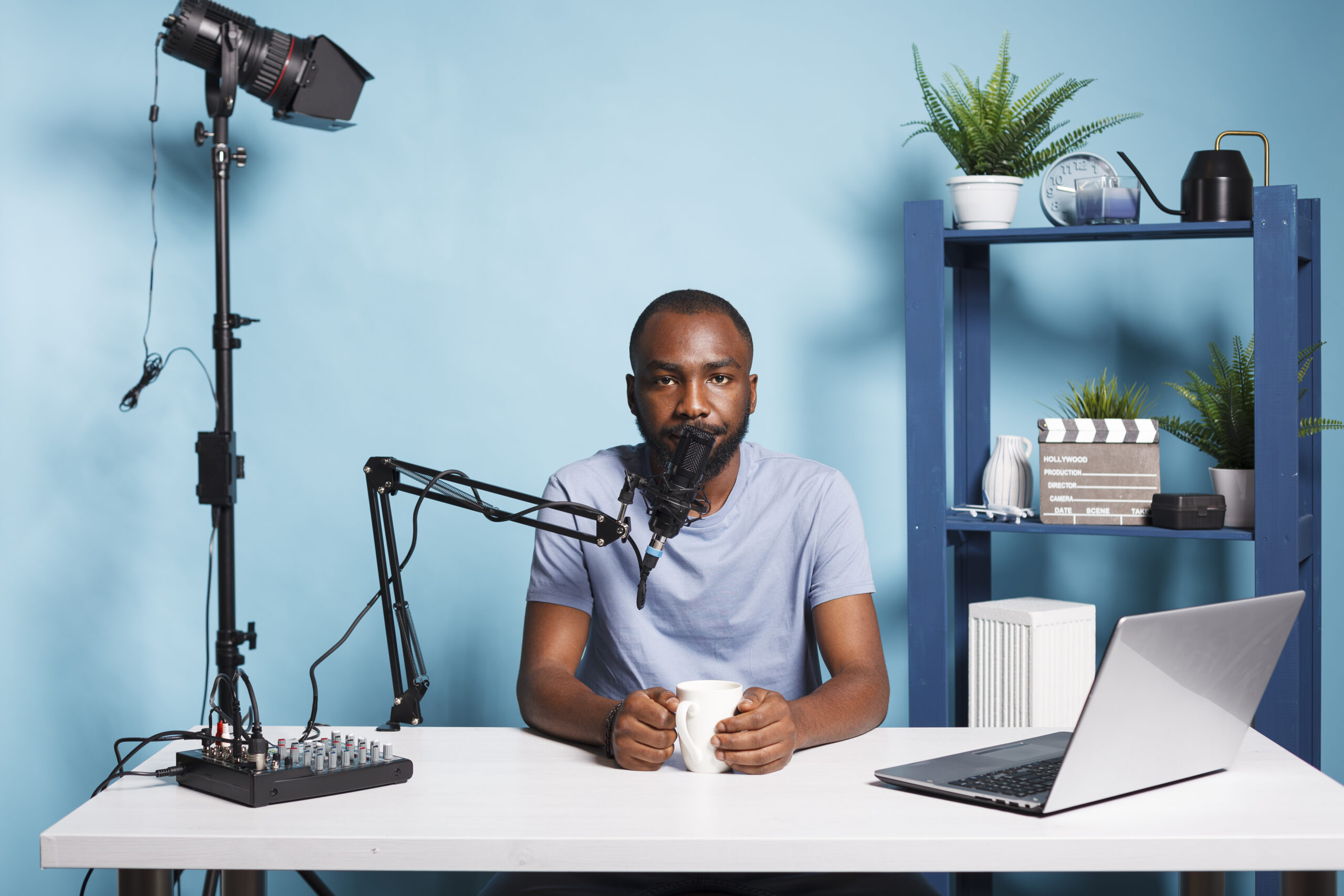 Blogger live streaming and broadcasting online for vlog video channel while looking at camera. African american man vlogger creating digital content and speaking on camera